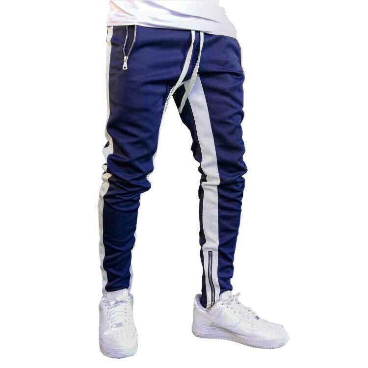Navy jogger pants with white side stripes and zippers, stylish look at FashionRay