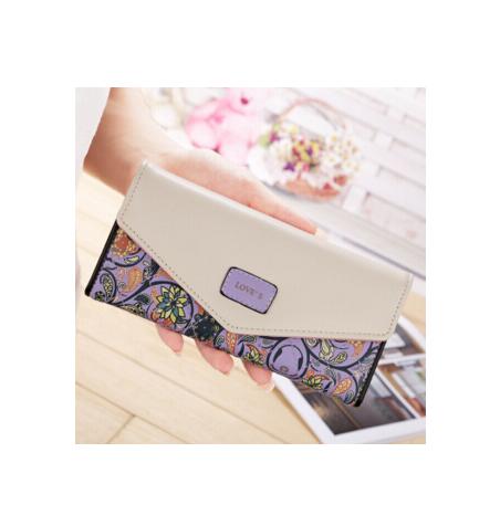Hand holding a FashionRay women's wallet with floral paisley design and cream flap