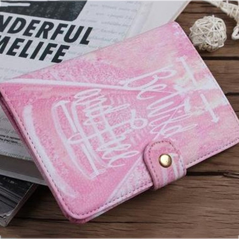 Pink wallet with white abstract design on wooden table, FashionRay trendy accessory