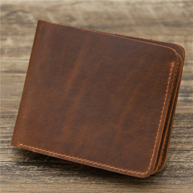 Brown leather wallet on wooden surface, stylish accessory at FashionRay