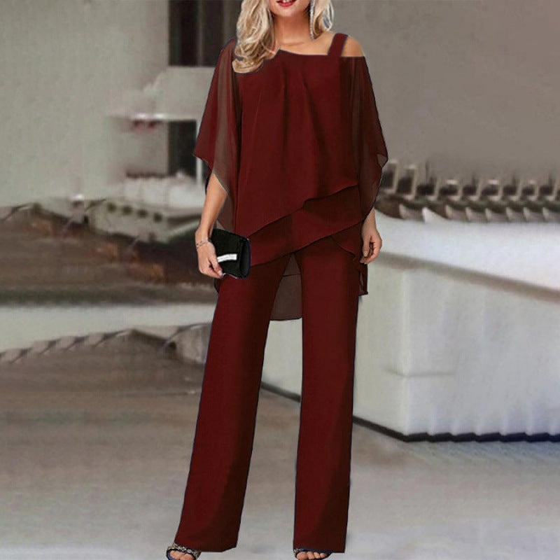 Woman in chic burgundy pantsuit with sheer overlay, stylish evening fashion at FashionRay