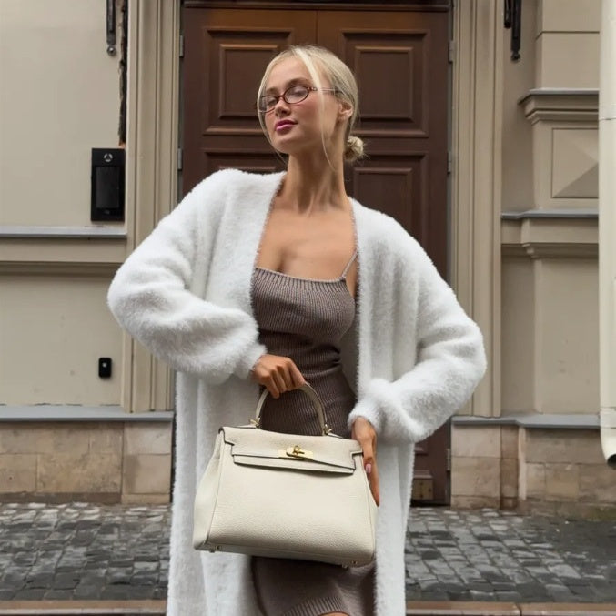 Woman in cozy white cardigan and fitted dress holding beige handbag, FashionRay street style