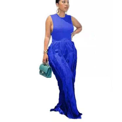 Woman in royal blue sleeveless maxi dress holding a teal handbag, FashionRay style