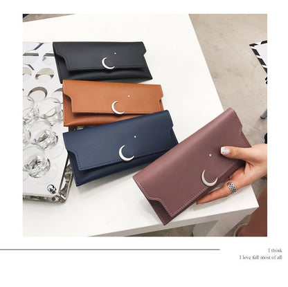 Assorted leather wallets with crescent moon and star details on a table, FashionRay accessories