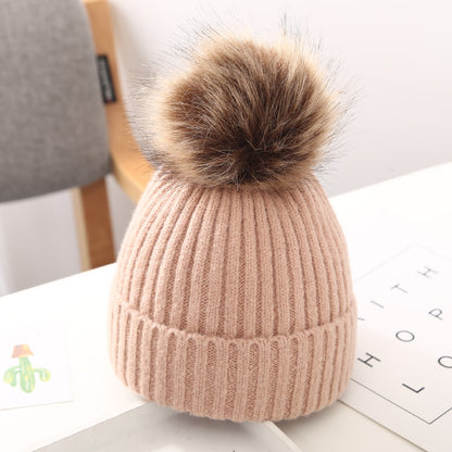 FashionRay pink knit beanie with faux fur pompom, cozy winter hat on desk