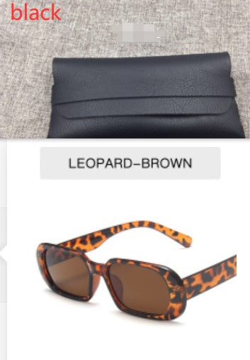 FashionRay black leather clutch on gray fabric and leopard-brown sunglasses duo for trendy style