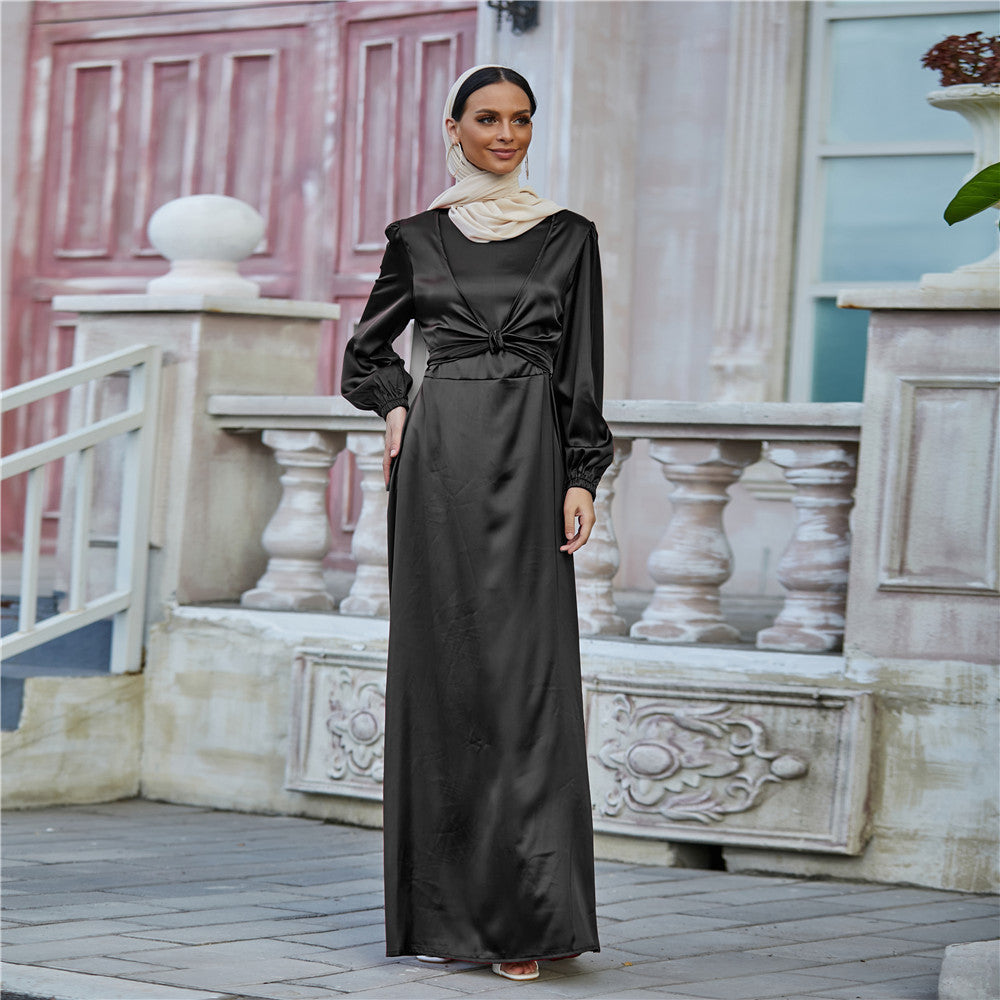 Woman in black satin maxi dress and beige headscarf posing outdoors, FashionRay style