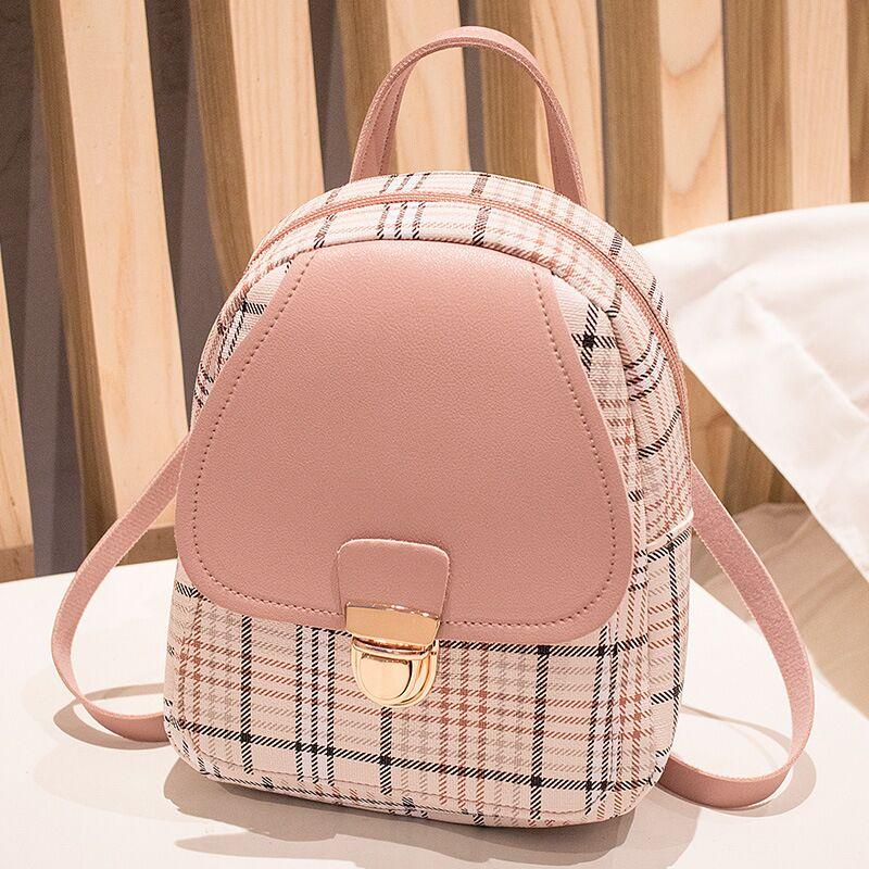 Trendy pink plaid mini backpack purse with gold clasp on table, FashionRay style