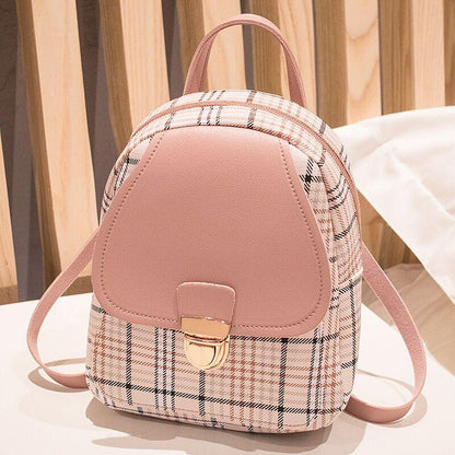 Trendy pink plaid mini backpack purse with gold clasp on table, FashionRay style