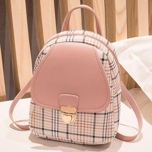 Trendy pink plaid mini backpack purse with gold clasp on table, FashionRay style