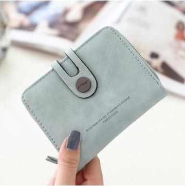 Light blue minimalist wallet held in hand, trendy accessory at FashionRay