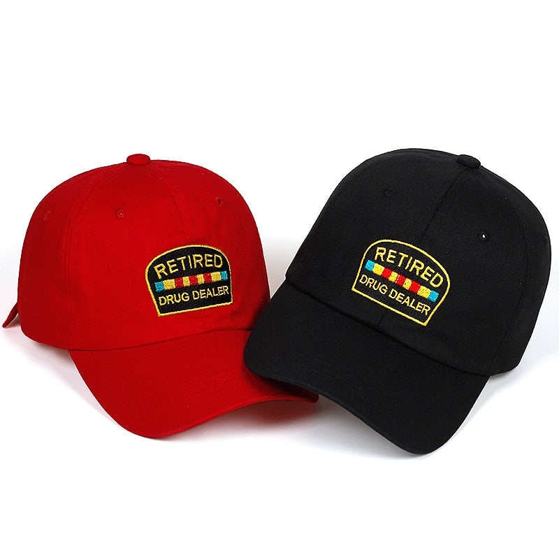 Red and black FashionRay baseball caps with 'Retired Drug Dealer' embroidered patch
