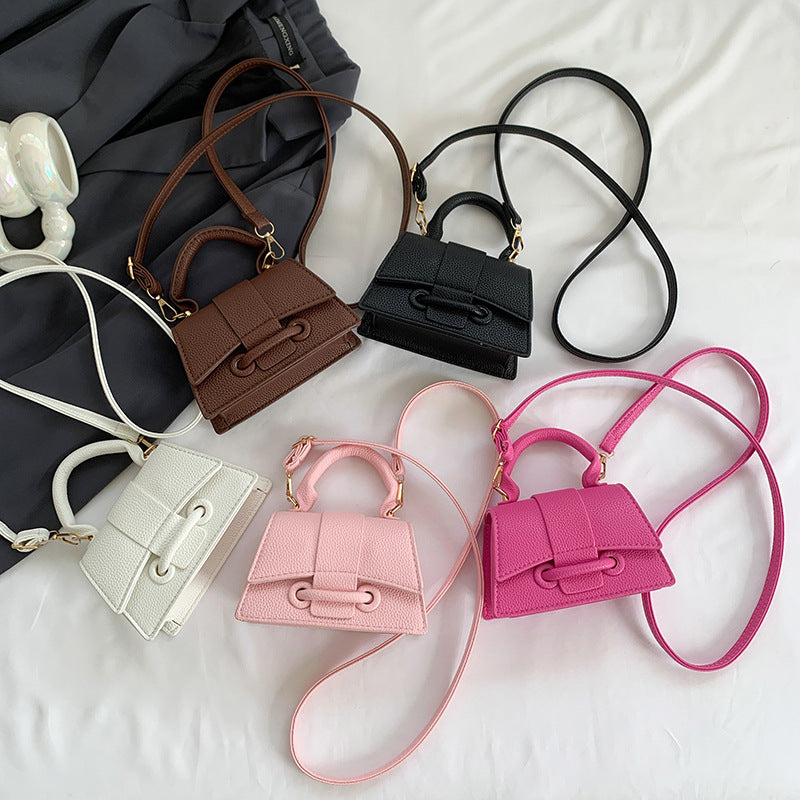 Trendy FashionRay mini crossbody handbags in black, brown, white, pink, and magenta on display