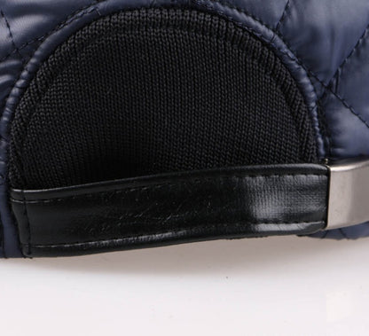 Closeup of navy quilted cap with black adjustable leather strap, FashionRay trendy accessory.