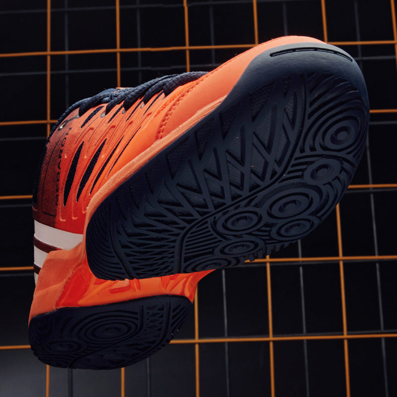 Bold orange and black athletic sneaker with textured sole, shown against a grid background