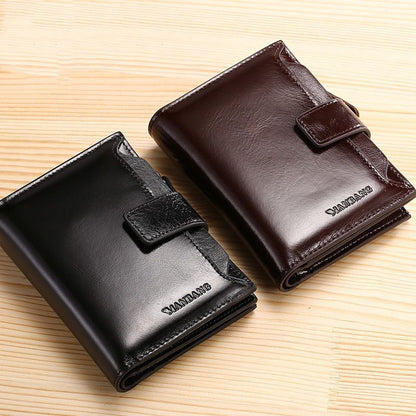 Black and brown leather wallets with clasp closures on a wooden surface, FashionRay accessories