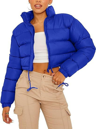 Woman modeling a trendy blue puffer jacket with beige cargo pants from FashionRay