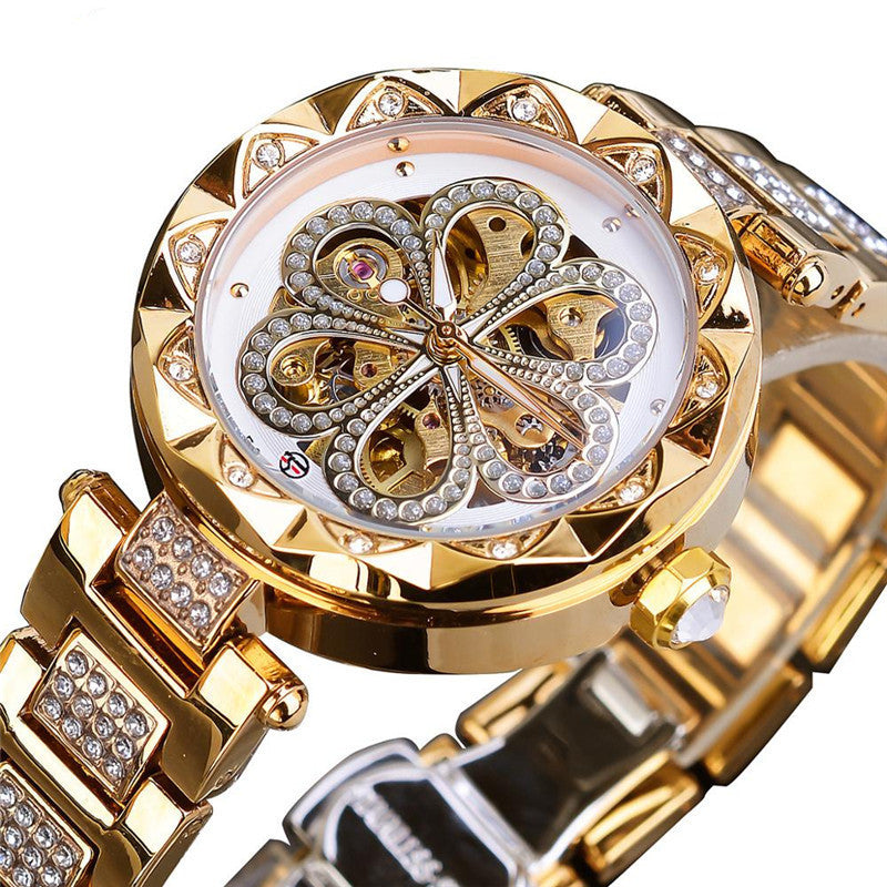 Luxury gold women's watch with crystal accents and intricate floral dial design, FashionRay