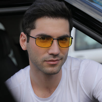 Man in a white shirt wearing yellow-lens sunglasses, sitting in a car, FashionRay style
