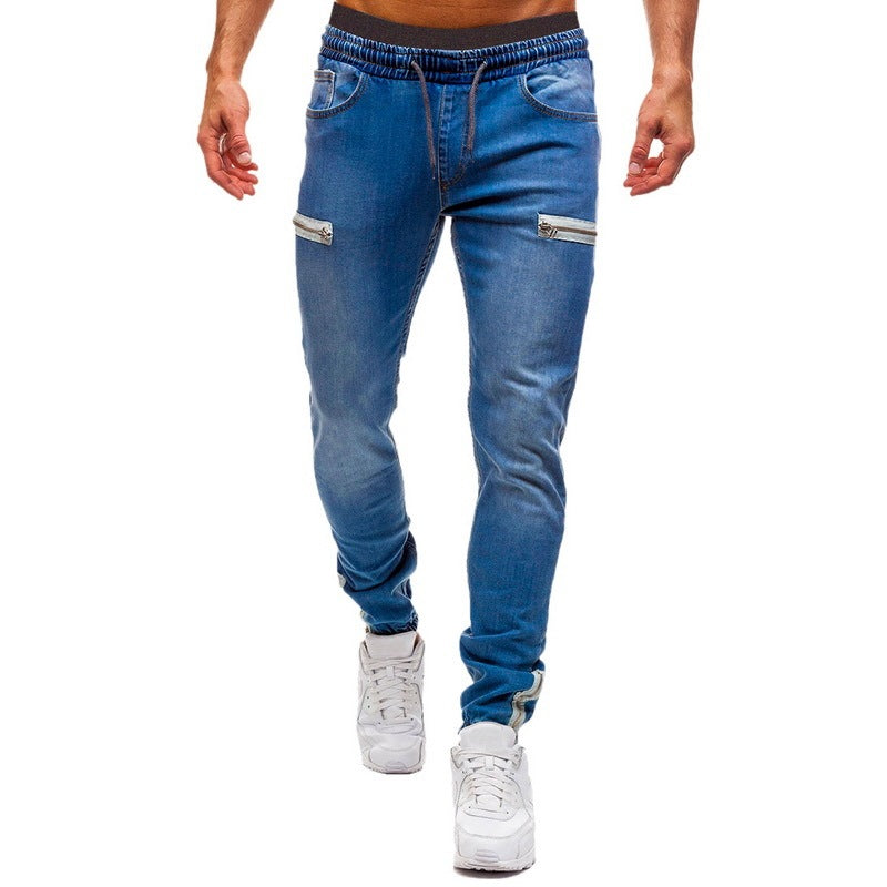 Men’s slim-fit blue jogger jeans with zipper pockets from FashionRay, styled with white sneakers.