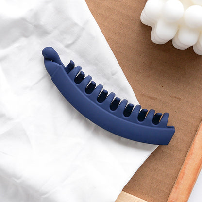 Navy blue banana hair clip on white fabric, FashionRay trendy hair accessory