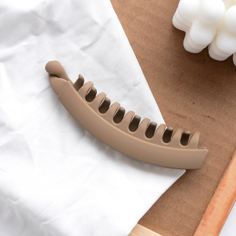 Matte brown hair clip on white fabric, FashionRay accessory, trendy minimalist style