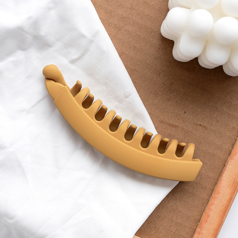 Matte beige hair clip on white cloth, with modern decor, FashionRay accessory style