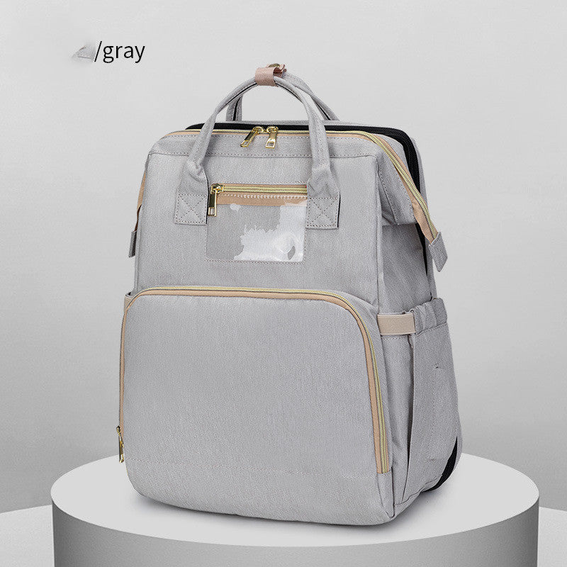 FashionRay stylish gray backpack with gold zippers on display pedestal