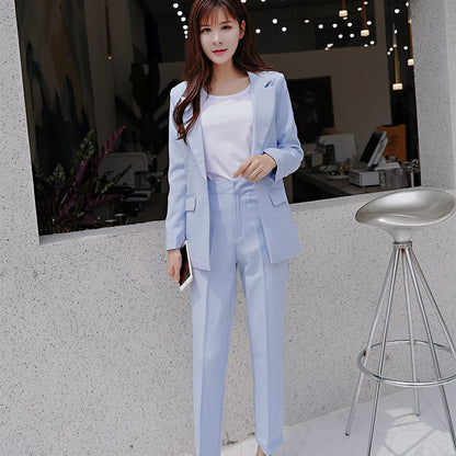 Woman in light blue suit with white top at modern café, trendy FashionRay style