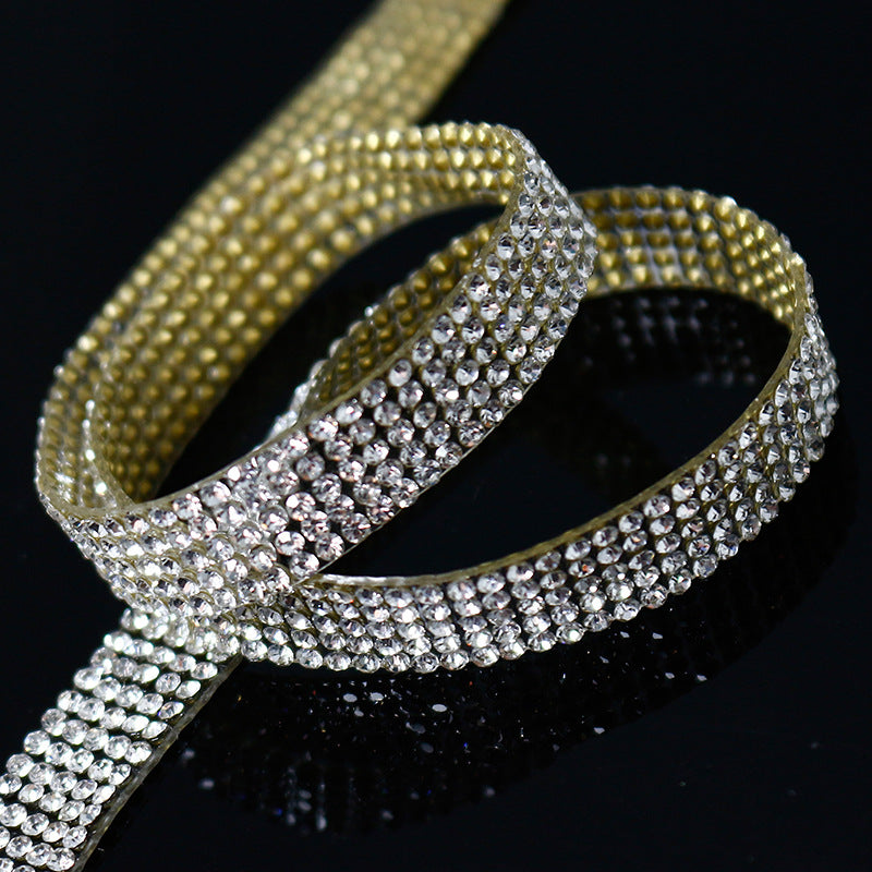 Gold rhinestone fashion ribbon sparkling against black background, FashionRay accessory style.