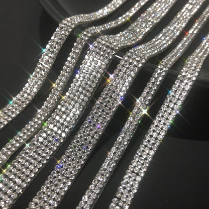 Rows of sparkling rhinestone belts on a black background, FashionRay trendy accessories