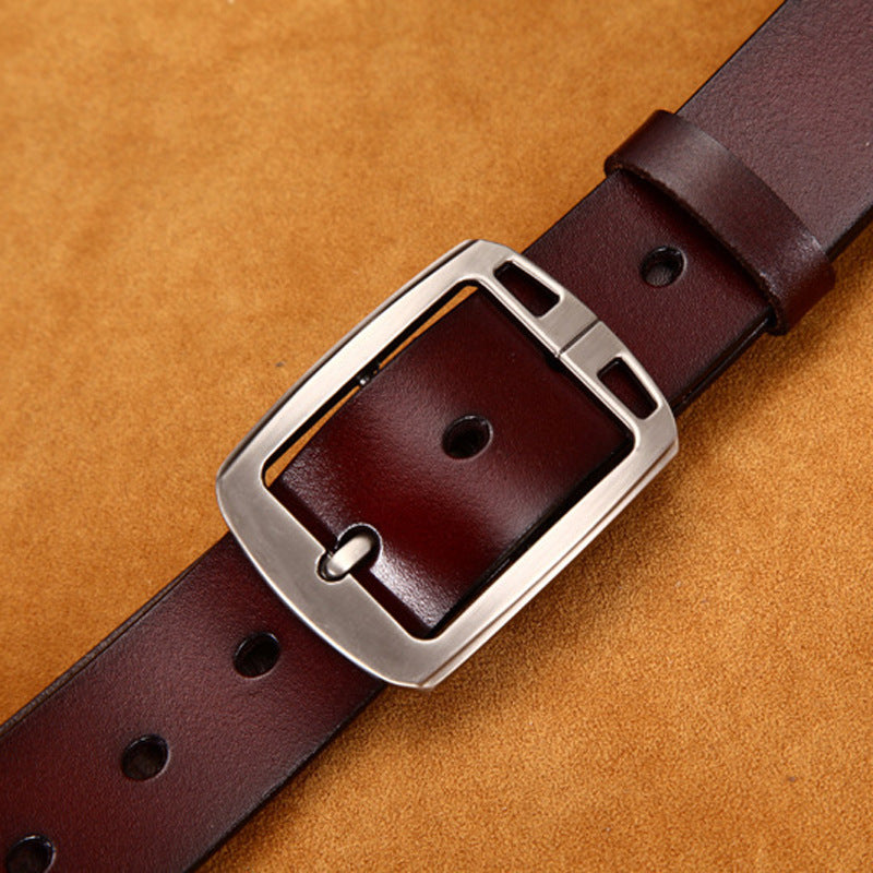 Brown leather belt with silver buckle on tan background, FashionRay accessory