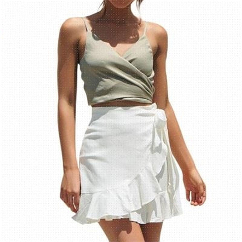 Woman in a light green tank top and white ruffle skirt, stylish summer outfit from FashionRay