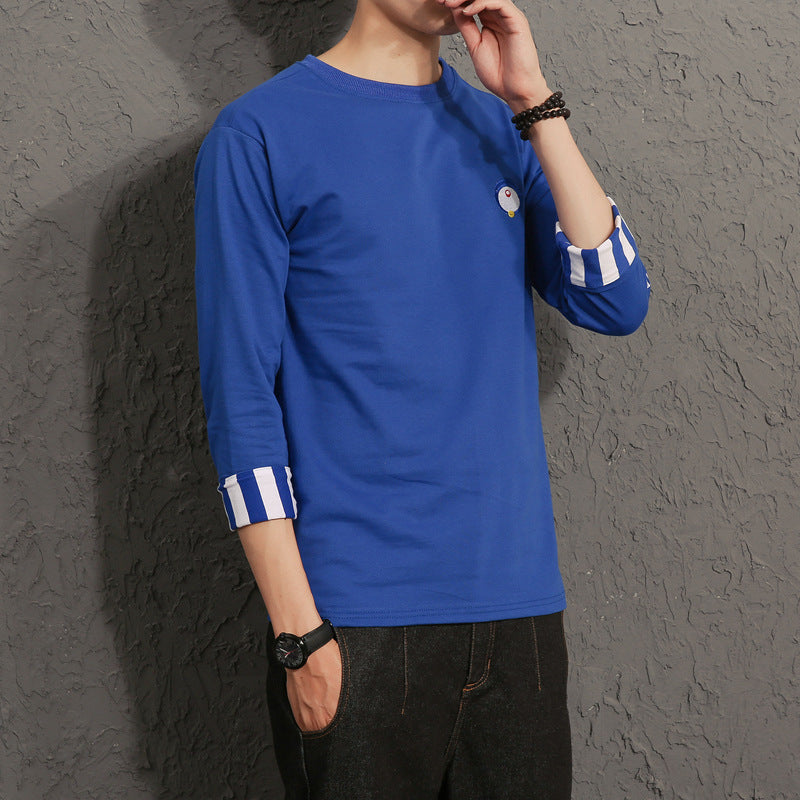 Man wearing a blue long-sleeve shirt with striped cuffs, casual FashionRay style