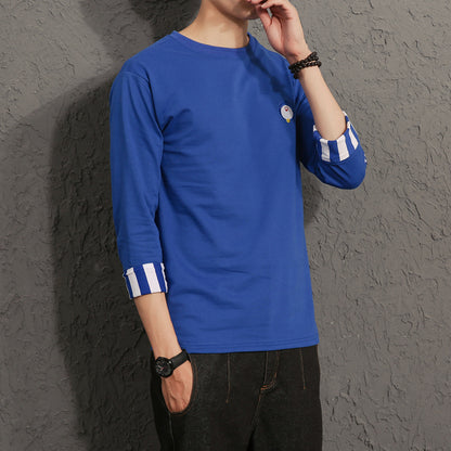 Man wearing a blue long-sleeve shirt with striped cuffs, casual FashionRay style