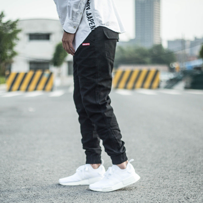 FashionRay streetwear look with black jogger pants and white sneakers outdoors