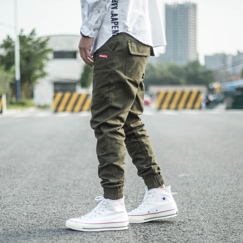 FashionRay street style: olive jogger pants and white high-top sneakers outdoors