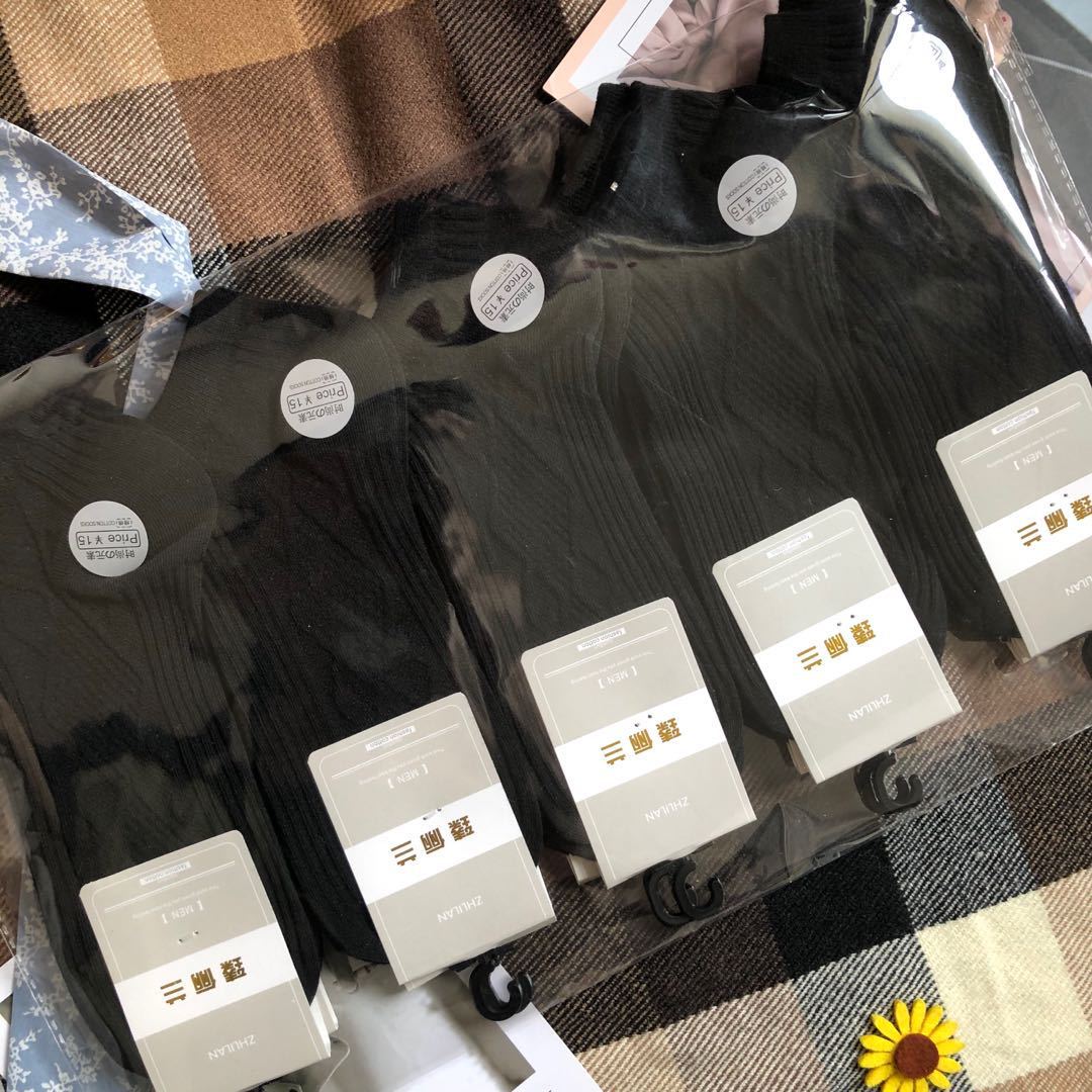 FashionRay pack of black ribbed socks on plaid fabric, trendy and comfortable style.