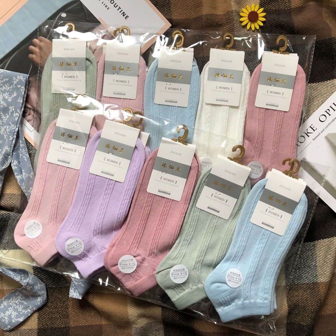 Colorful women's socks multipack with ZHILAN labels, laid out on a plaid surface, FashionRay