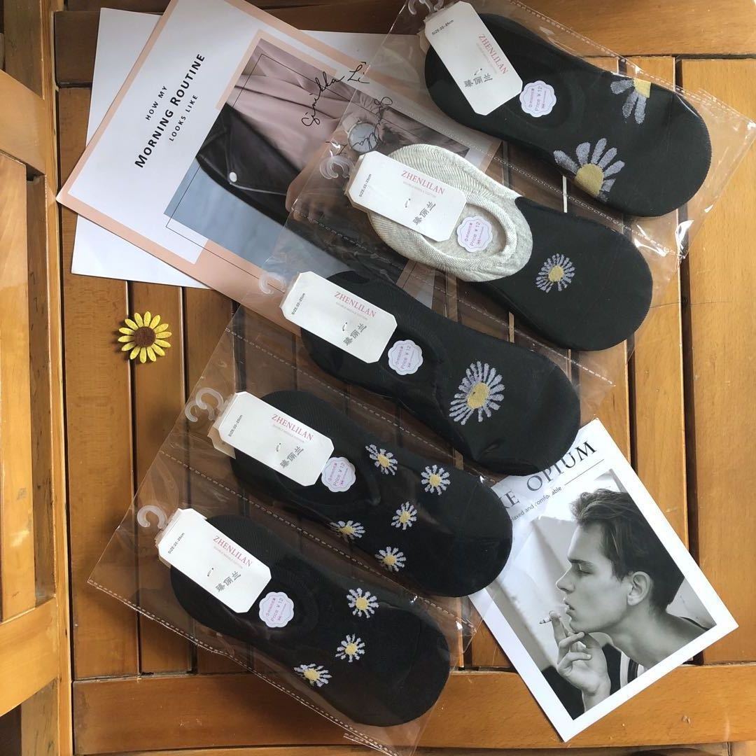 Floral patterned fashion socks in black and white on wooden table, FashionRay style accessories