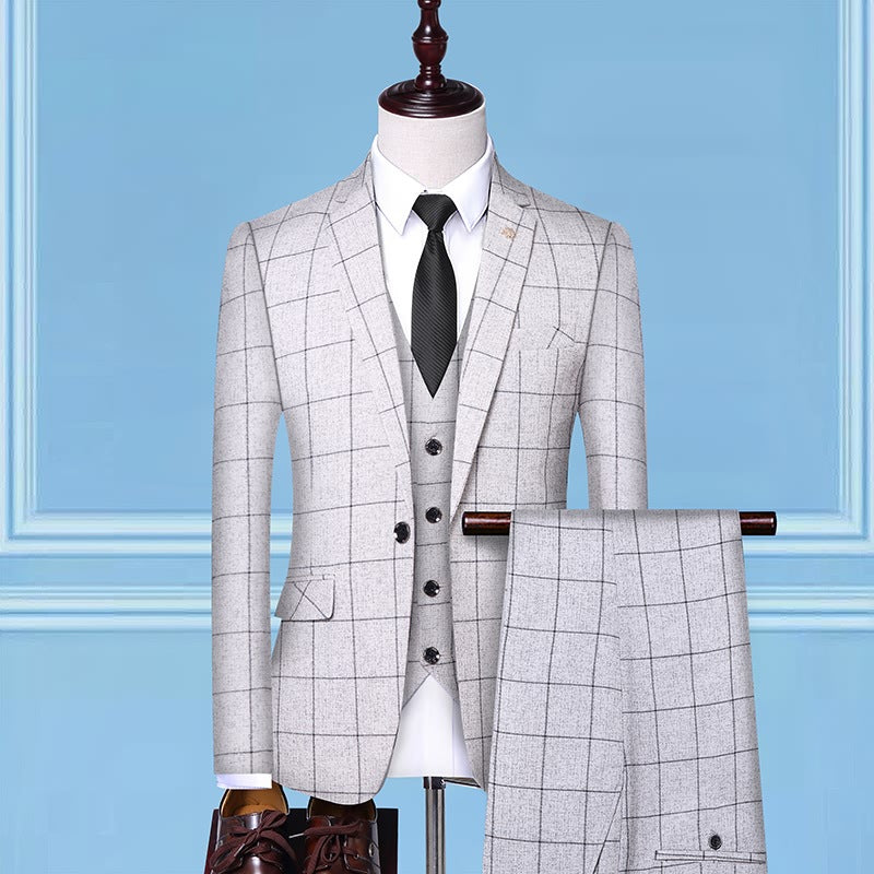 Light gray windowpane check suit with vest, white shirt, black tie, and dress shoes on mannequin, FashionRay style.