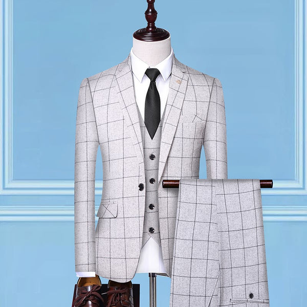 Light gray windowpane check suit with vest, white shirt, black tie, and dress shoes on mannequin, FashionRay style.