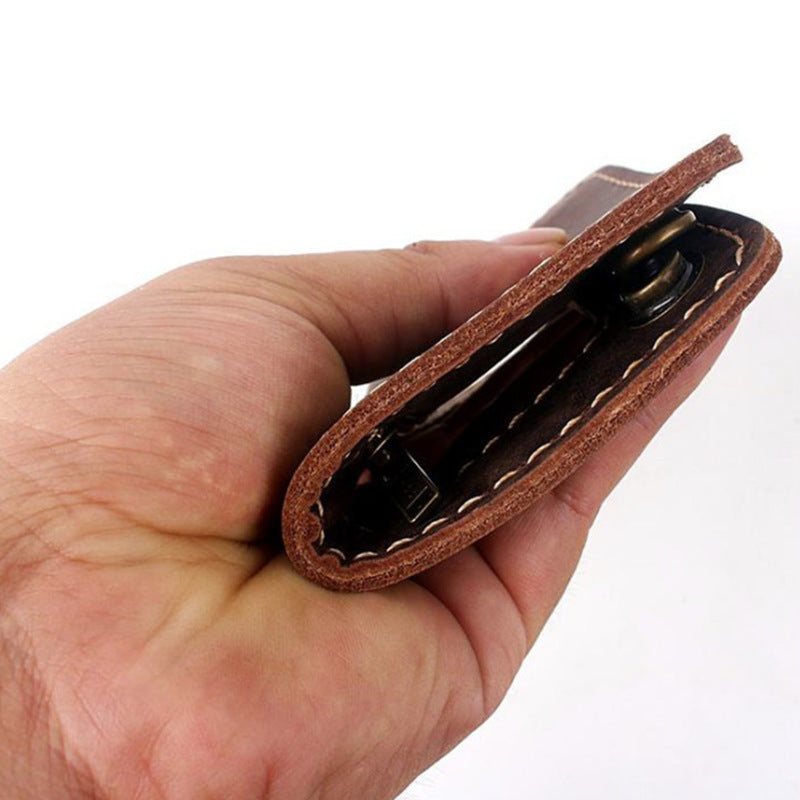 Hand holding brown leather key case with visible stitching, FashionRay accessories