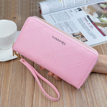 FashionRay pink zippered wristlet wallet with textured pattern on wooden table