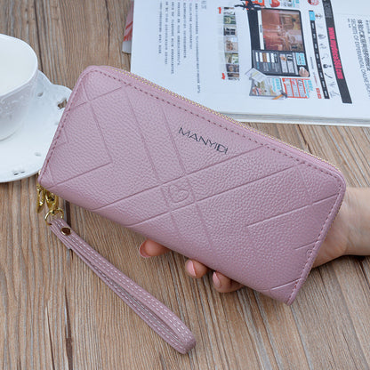 Pink textured wristlet wallet on wooden table, stylish women's accessory from FashionRay