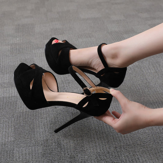 Woman wearing black high heel sandals with ankle strap on gray carpet, FashionRay style