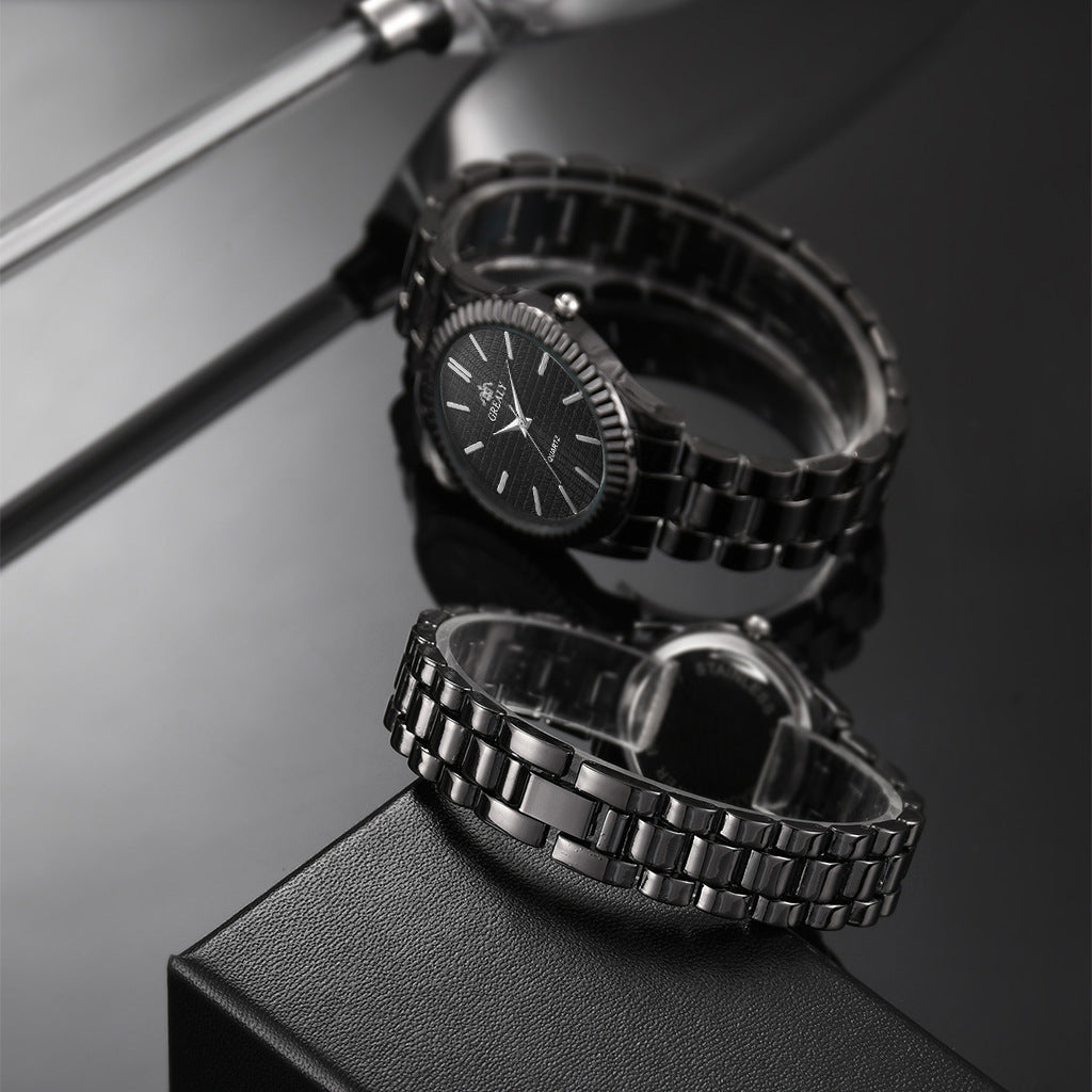 Sleek black metal watch with textured dial on reflective surface, FashionRay style accessory