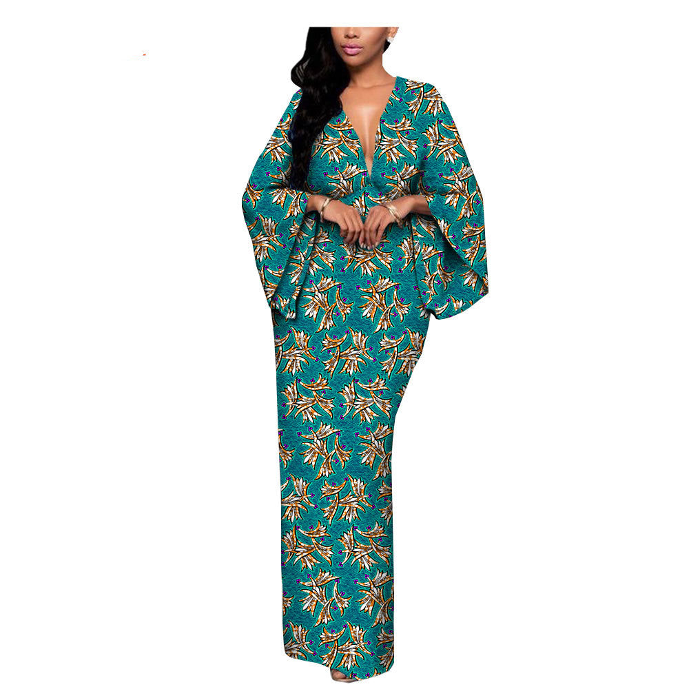 Woman in teal floral maxi dress with wide sleeves, FashionRay trendy bold style