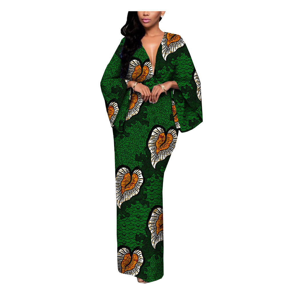 Woman wearing a bold green and orange patterned maxi dress from FashionRay