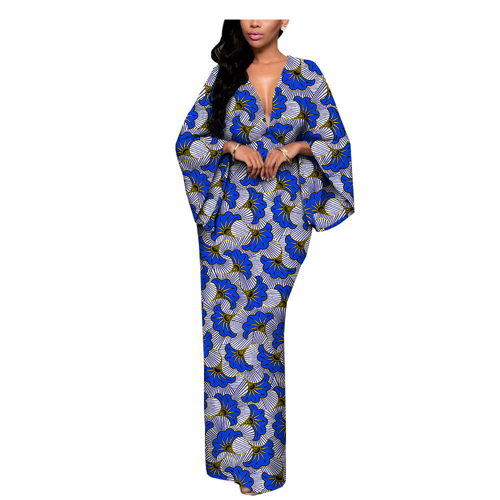 Woman wearing a blue floral print maxi dress with wide sleeves, FashionRay bold style